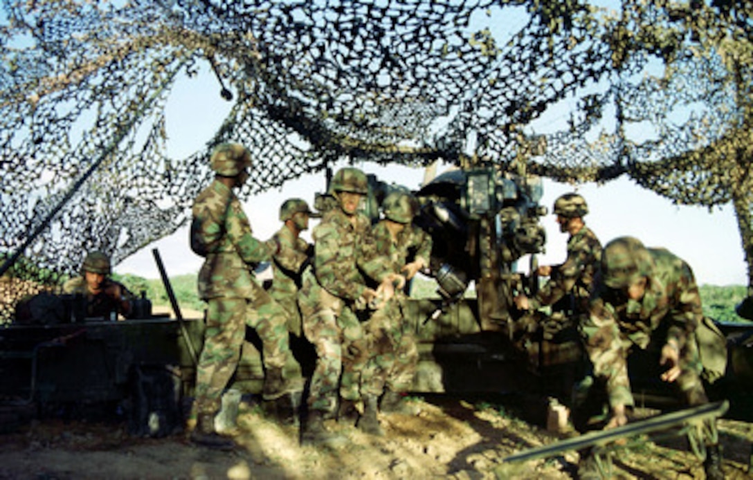 Soldiers from B Battery ram a high explosive round into their M-198 155 mm howitzer on Vieques Island, Puerto Rico, on Jan. 20, 1998, during Joint Task Force Exercise 98-1. More than 30,000 U.S. military personnel are participating in the exercise which is testing joint forces on their ability to deploy rapidly and conduct joint operations during a crisis. All branches of the armed forces are training side-by-side using the latest advances in technology in a simulated high-threat environment that involves air, naval and ground operations. B Battery, which is from 1st Battalion, 377th Field Artillery Regiment (Air Assault), Fort Bragg, N.C., is conducting a joint, live fire exercise with the 26th Marine Expeditionary Unit of Camp Lejeune, N.C. 