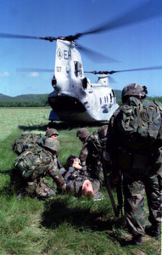 U.S. Marines from Kilo Battery, Battalion Landing Team 3/2 tend to a simulated injured pilot during a Tactical Recovery of Aircraft and Personnel, or TRAP, mission aboard Vieques Island, Puerto Rico, on Jan. 22, 1998, during Joint Task Force Exercise 98-1. More than 30,000 U.S. military personnel are participating in the exercise which is testing joint forces on their ability to deploy rapidly and conduct joint operations during a crisis. All branches of the armed forces are training side-by-side using the latest advances in technology in a simulated high-threat environment that involves air, naval and ground operations. Kilo Battery, Battalion Landing Team 3/2 is made up of personnel from the 3rd Battalion, 2nd Marine Regiment. 