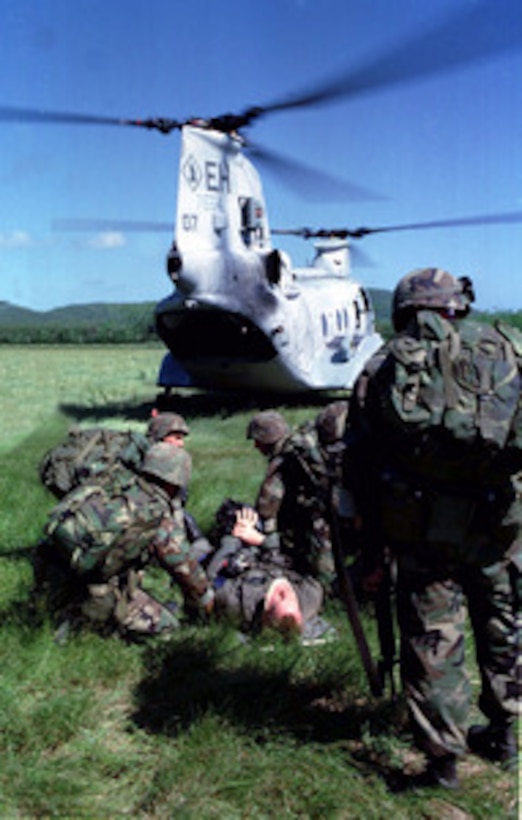 U.S. Marines from Kilo Battery, Battalion Landing Team 3/2 tend to a simulated injured pilot during a Tactical Recovery of Aircraft and Personnel, or TRAP, mission aboard Vieques Island, Puerto Rico, on Jan. 22, 1998, during Joint Task Force Exercise 98-1. More than 30,000 U.S. military personnel are participating in the exercise which is testing joint forces on their ability to deploy rapidly and conduct joint operations during a crisis. All branches of the armed forces are training side-by-side using the latest advances in technology in a simulated high-threat environment that involves air, naval and ground operations. Kilo Battery, Battalion Landing Team 3/2 is made up of personnel from the 3rd Battalion, 2nd Marine Regiment. 