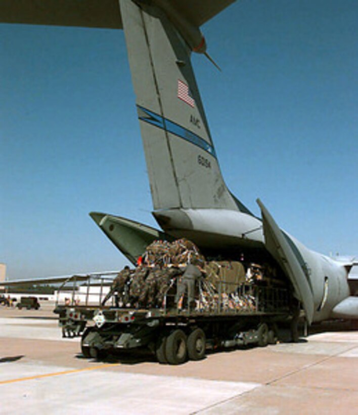 Soldiers from the 82nd Airborne Division push pallets of equipment into a U.S. Air Force C-141 Starlifter at Pope Air Force Base, N.C., on Jan. 26, 1998. Nearly 80 aircraft will airdrop personnel and equipment into a Fort Bragg landing zone in one of the largest airborne operations since World War II as part of Joint Task Force Exercise 98-1. More than 30,000 U.S. military personnel are participating in the exercise which is testing joint forces on their ability to deploy rapidly and conduct joint operations during a crisis. All branches of the armed forces are training side-by-side using the latest advances in technology in a simulated high-threat environment that involves air, naval and ground operations. The Starlifter is deployed from McGuire Air Force Base, N.J. 