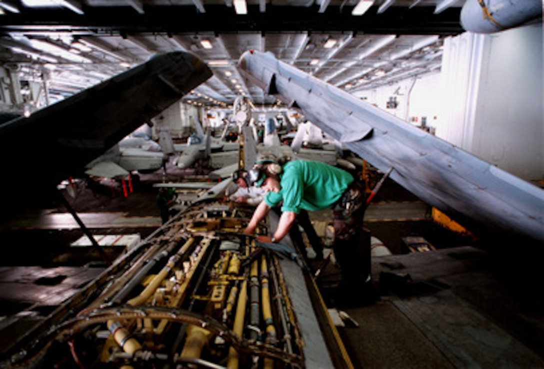 Airman Apprentice Nathan Fentress performs corrosion protection maintenance on an EA-6B Prowler in the hangar deck of the USS George Washington (CVN 73) as the ship steams in the Persian Gulf on Jan. 2, 1998. The Washington battle group is operating in the Persian Gulf in support of Operation Southern Watch which is the U.S. and coalition enforcement of the no-fly-zone over Southern Iraq. Fentress, a Navy aviation structural mechanic, is from Haden, Colo. The Prowler belongs to Tactical Electronic Warfare Squadron 137. 