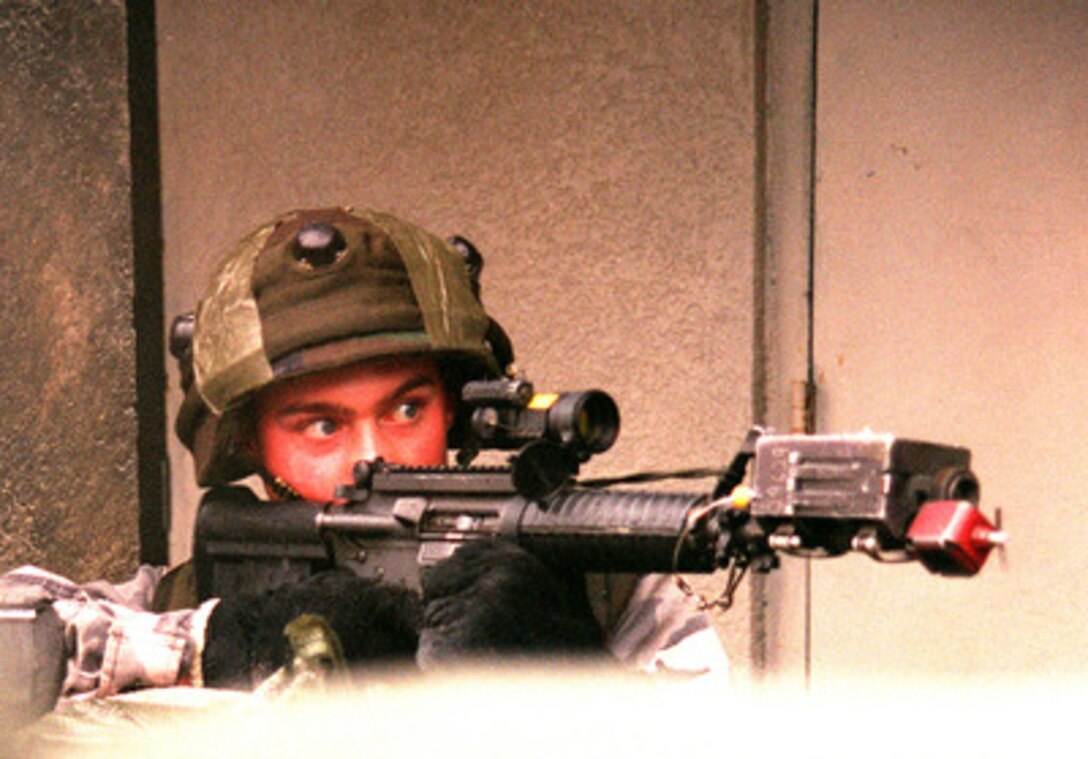 A U.S. Marine looks down the scope of his M-16A2 rifle as he maneuvers through the Military Operations in Urban Terrain facility in a at Camp Lejeune, N.C. on Jan. 23, 1998, during Urban Warrior. Urban Warrior is the U.S. Marine Corps Warfighting Laboratory's series of limited objective experiments examining new urban tactics and experimental technologies. The experiment is being conducted by the Special Purpose Marine Air-Ground Task Force (Experimental) from Quantico, Va., and Charlie Company, 1st Battalion, 6th Marines from Camp Lejeune, with support from the 2nd Marine Expeditionary Force. 