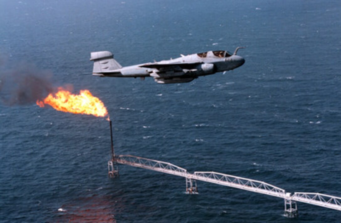 A U.S. Navy EA-6B Prowler attached to Tactical Electronic Warfare Squadron 137 flies over an oil rig in the Persian Gulf on Jan. 23, 1998. The Prowler is flying off of the aircraft carrier USS George Washington (CVN 73). The Washington battle group is operating in the Persian Gulf in support of Operation Southern Watch which is the U.S. and coalition enforcement of the no-fly-zone over Southern Iraq. 