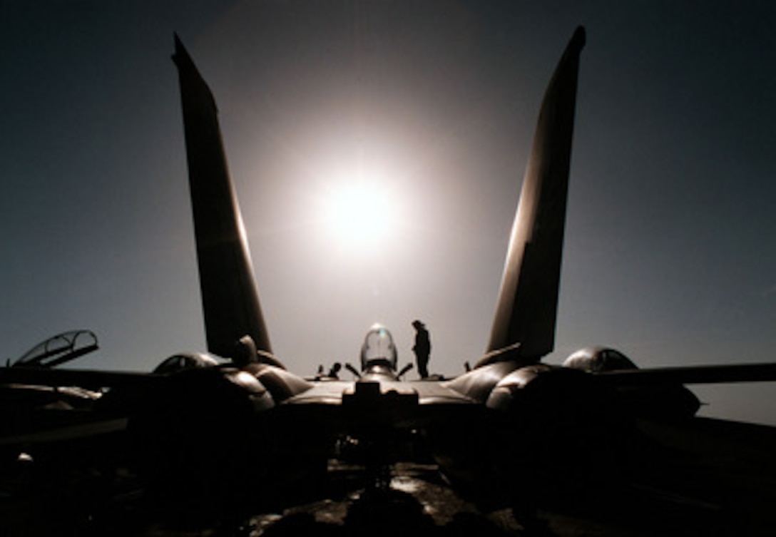 An aircraft mechanic from Fighter Squadron 102 works on an F-14B Tomcat on the flight deck of the USS George Washington (CVN 73) as the ship steams in the Persian Gulf on Feb. 2, 1998. The Washington battle group is operating in the Persian Gulf in support of Operation Southern Watch which is the U.S. and coalition enforcement of the no-fly-zone over Southern Iraq. Fighter Squadron 102 is deployed to the Washington from Naval Air Station Oceana, Va. 