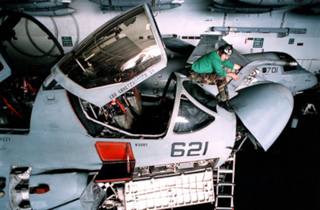 Petty Officer 1st Class Michael Walcott performs maintenance on an EA-6B Prowler in the hangar deck of the USS George Washington (CVN 73) as the ship steams in the Persian Gulf on Jan. 2, 1998. The Washington battle group is operating in the Persian Gulf in support of Operation Southern Watch which is the U.S. and coalition enforcement of the no-fly-zone over Southern Iraq. Walcott, from Athens, Pa., is a Navy aviation machinist's mate. The Prowler belongs to Tactical Electronic Warfare Squadron 137. 