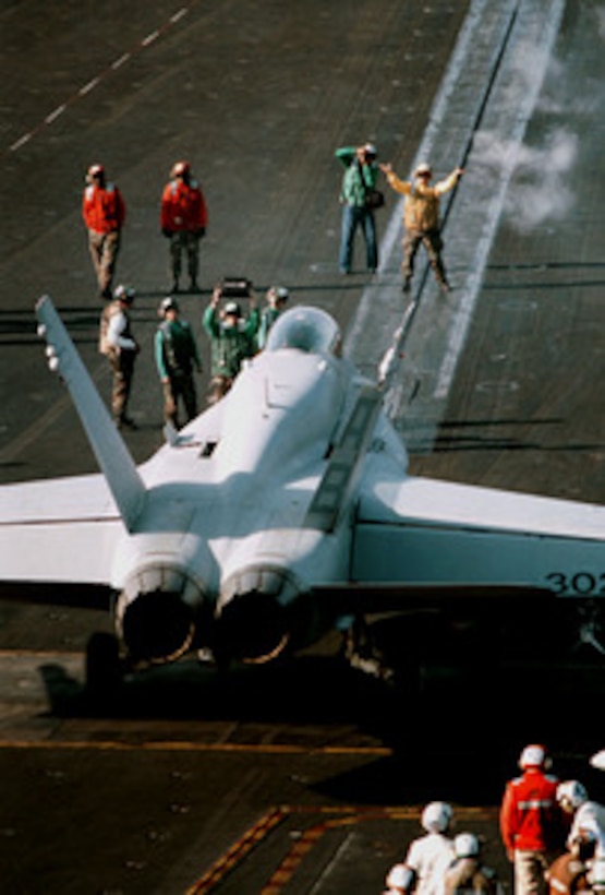 An F/A-18C Hornet is directed onto the catapult in preparation for launch from the flight deck of USS George Washington (CVN 73) as the ship steams in the Persian Gulf on Feb. 5, 1998. The Washington battle group is operating in the Persian Gulf in support of Operation Southern Watch which is the U.S. and coalition enforcement of the no-fly-zone over Southern Iraq. 