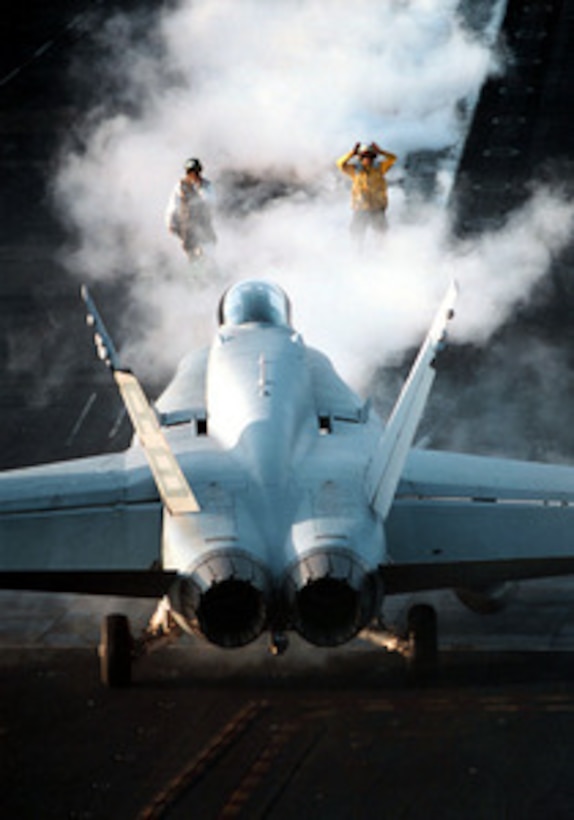 Steam surrounds flight deck crewmen as they direct a U.S. Marine Corps F/A-18C Hornet onto the catapult in preparation for launch from the USS George Washington (CVN 73) as the ship steams in the Persian Gulf on Feb. 6, 1998. The Washington battle group is operating in the Persian Gulf in support of Operation Southern Watch which is the U.S. and coalition enforcement of the no-fly-zone over Southern Iraq. The Hornet is attached to Fighter-Attack Squadron 251 from Marine Corps Air Station Beaufort, S.C. 