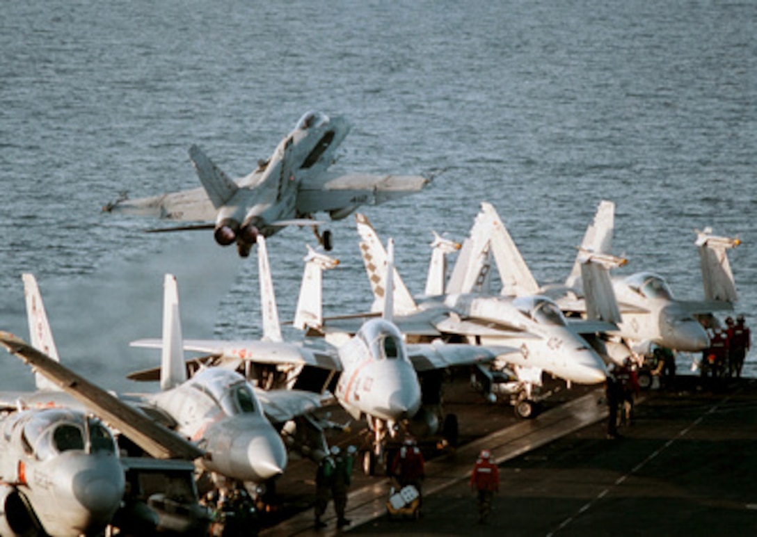 An F/A-18C Hornet launches from the waist catapult of the USS George Washington (CVN 73) as the ship steams in the Persian Gulf on Feb. 6, 1998. The Washington battle group is operating in the Persian Gulf in support of Operation Southern Watch which is the U.S. and coalition enforcement of the no-fly-zone over Southern Iraq. The Hornet is attached to Strike Fighter Squadron 86 of Naval Air Station Cecil Field, Fla. 