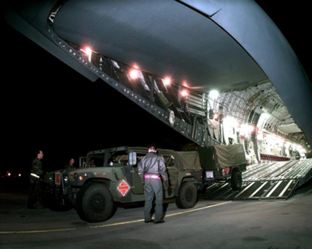 A 437th Civil Engineer Squadron explosive ordnance disposal team Humvee and trailer are backed onto the cargo ramp of a C-17A Globemaster III at Charleston Air Force Base, S.C., on Feb. 8, 1998. The Globemaster is air-lifting personnel and vehicles of the 437th Civil Engineer Squadron, Fire Department, and Explosive Ordnance Disposal Unit, from Charleston to the Persian Gulf region. 