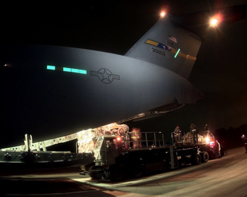 A 437th Aerial Port Squadron K-loader delivers cargo pallets to the cargo ramp of a C-17A Globemaster III at Charleston Air Force Base, S.C., on Feb. 8, 1998. The Globemaster is air-lifting personnel, equipment and vehicles of the 437th Civil Engineer Squadron, Fire Department, and Explosive Ordnance Disposal Unit, from Charleston to the Persian Gulf region. 