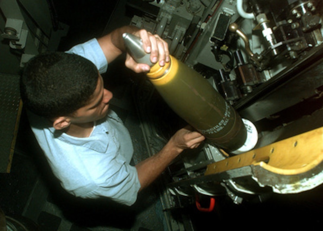 Petty Officer 3rd Class Walter Vanderhorst loads projectiles into the 5-inch gun aboard the Spruance-class destroyer USS John Young (DD 973) as the ship operates in the Persian Gulf on Feb. 9, 1998. The John Young is deployed from its homeport of San Diego, Calif., to the Persian Gulf in support of Operation Southern Watch which is the U.S. and coalition enforcement of the no-fly-zone over Southern Iraq. Vanderhorst, of Queens, N.Y., is a Navy gunner's mate. 