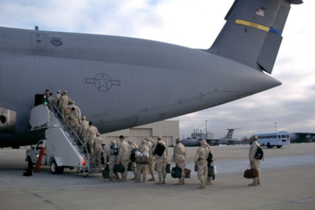 U.S. Air Force personnel from the 821st Air Mobility Squadron, McGuire Air Force Base, N.J., board a C-5 Galaxy on Feb. 8, 1998, for deployment to the Persian Gulf Region. 