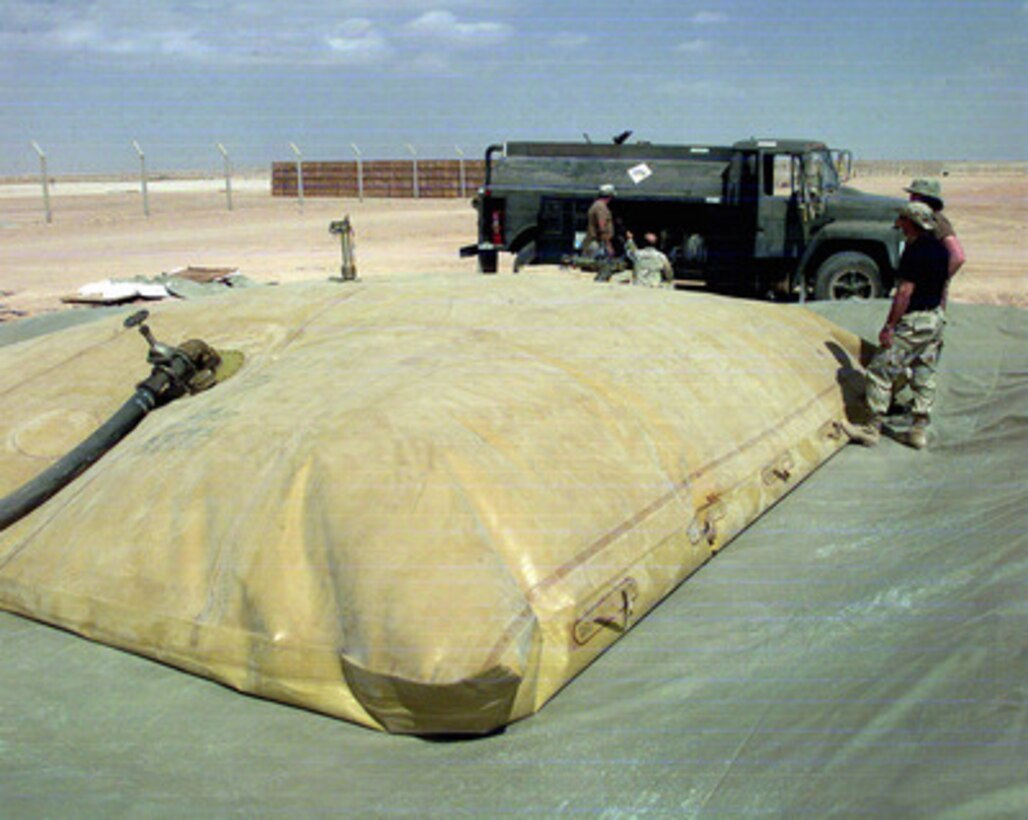 U.S. Air Force personnel from the 89th Civil Engineering Squadron build a fuel-bladder holding facility at an operating base in Southwest Asia on Feb. 15, 1998. The engineers are part of an Air Mobility Command Tanker Task Force operating in the Southwest Asia theater in support of Operation Southern Watch which is the U.S. and coalition enforcement of the no-fly-zone over Southern Iraq. The engineers of the 89th are deployed to the Gulf region from Andrews Air Force Base, Md. 