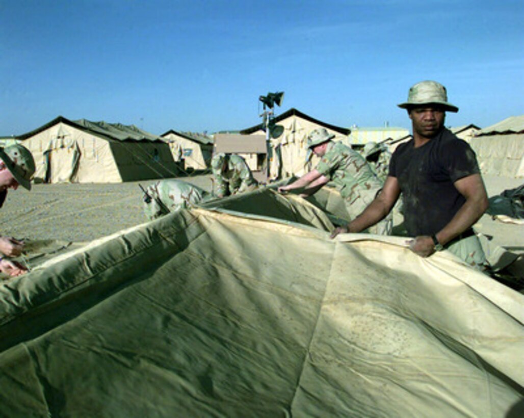 Staff Sgt. Darryl Conny, from the 89th Civil Engineering Squadron, helps to build a tent city at an operating base in Southwest Asia on Feb. 17, 1998. The engineers are part of an Air Mobility Command Tanker Task Force operating in the Southwest Asia theater in support of Operation Southern Watch. Southern Watch is the U.S. and coalition enforcement of the no-fly-zone over Southern Iraq. The engineers of the 89th are deployed to the Gulf region from Andrews Air Force Base, Md. 