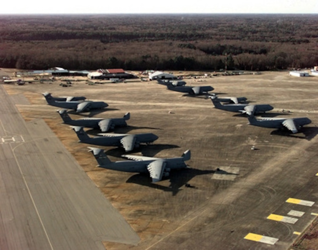 U.S. Air Force C-5 Galaxys, C-141 Starlifters and C-17 Globemasters III from the Air Mobility Command sit on the parking ramp as they wait for loading at Hunter Army Air Field, Ga., on Feb. 17, 1998. The aircraft will airlift equipment and personnel to the Southwest Asia theater in support of Operation Southern Watch. Southern Watch is the U.S. and coalition enforcement of the no-fly-zone over Southern Iraq. The Starlifters are from the 315th Wing, McGuire Air Force Base, N.J. The Globemasters are from the 437th Wing, Charleston Air Force Base, S.C. The Galaxys are from the 60th Wing, Travis Air Force Base, Calif., and the 436th Wing from Dover Air Force Base, Del. 