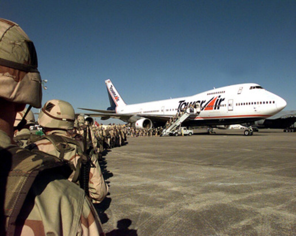 Soldiers of the 3rd Battalion, 69th Armor of the 3rd Infantry, Fort Stewart, Ga., line up to board a Tower Air charter aircraft at Hunter Army Air Field, Ga., for deployment to the Persian Gulf region on Feb. 18, 1998. The soldiers are deploying to the Southwest Asia theater in support of Operation Southern Watch. Southern Watch is the U.S. and coalition enforcement of the no-fly-zone over Southern Iraq. 