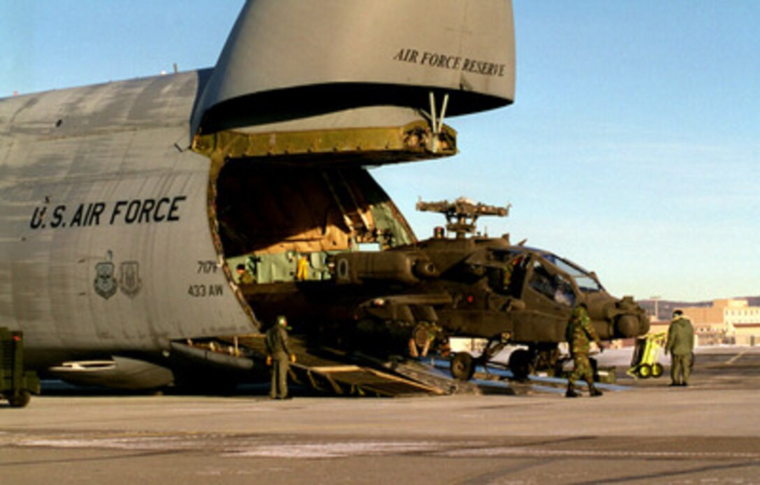 A U.S. Army AH-64 Apache helicopter is winched down the ramp of a National Guard C-5 Galaxy at Eielson Air Force Base, Alaska, on Feb. 6, 1998, in preparation for Exercise Northern Edge 98. More than 90,000 soldiers, sailors, Marines, airmen Coast Guardsmen and National Guardsmen are participating the exercise. Northern Edge 98 is designed to practice joint operational techniques and procedures, increasing interoperability between the services. The Apache is attached to the 4th Battalion, 3rd Armored Cavalry Regiment, Fort Carson, Colo. The Galaxy is deployed from Kelly Air Force Base, Texas. 