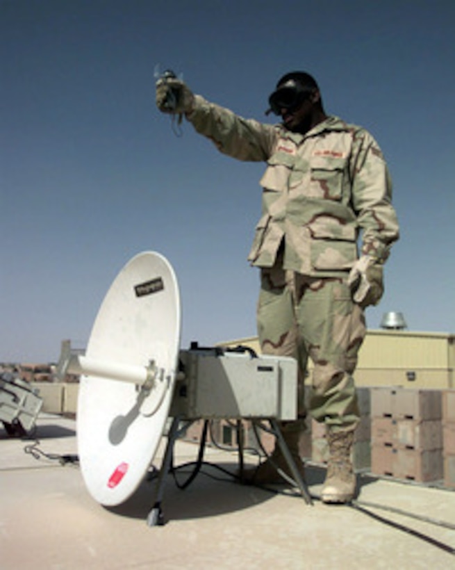 Senior Airman Steven Johnson uses a hand-held compass to shoot an azimuth in order to position his International Maritime Satellite dish for a mobile phone at an operating base in Southwest Asia on Feb. 16, 1998. Johnson is one of over 400 U.S. Air Force personnel deployed to the Gulf region as part of an Air Mobility Command Tanker Task Force operating in the Southwest Asia theater in support of Operation Southern Watch. Southern Watch is the U.S. and coalition enforcement of the no-fly-zone over Southern Iraq. Johnson is deployed from the 621st Air Mobility Operations Squadron, McGuire Air Force Base, N.J. 