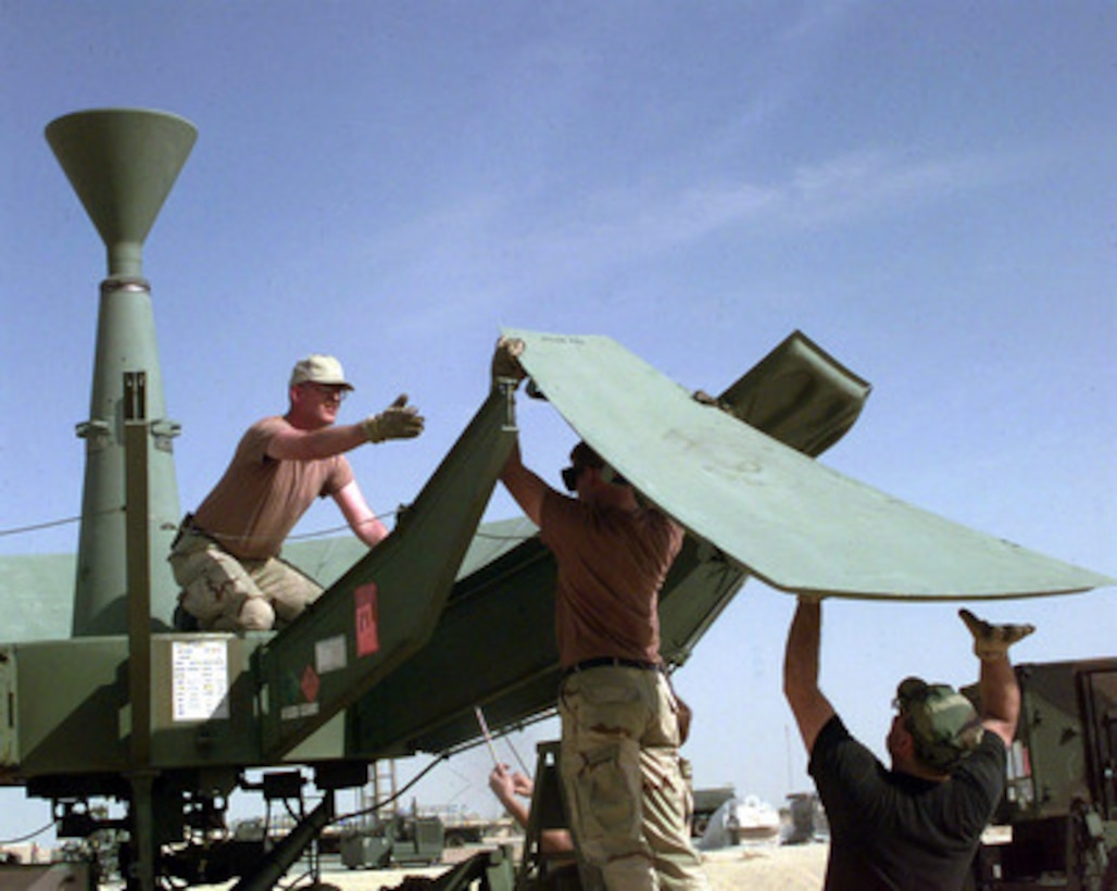 U.S. Air Force personnel from the 51st, 52nd and the 54th Combat Communications Squadrons set up a 20 foot Quick Reaction Satellite Antenna at an operating base in Southwest Asia on Feb. 16, 1998. Over 400 U.S. Air Force personnel are deployed to the Gulf region as part of an Air Mobility Command Tanker Task Force operating in the Southwest Asia theater in support of Operation Southern Watch. Southern Watch is the U.S. and coalition enforcement of the no-fly-zone over Southern Iraq. The antenna will give the deployed Tanker Task Force direct, worldwide communications. The 51st, 52nd and the 54th are deployed from Robins Air Force Base, Ga. 