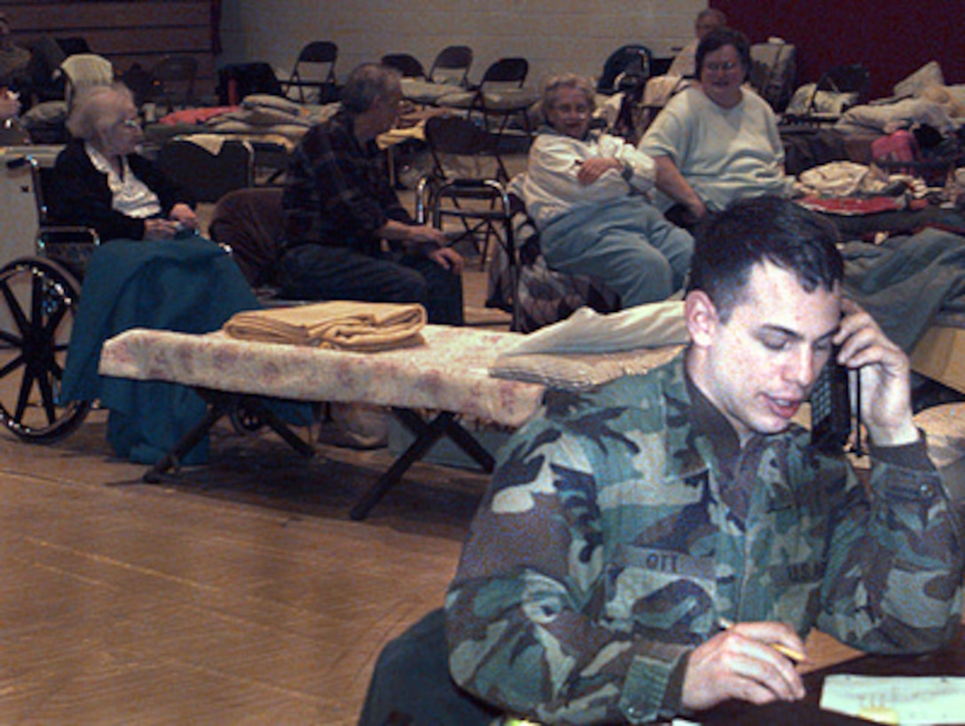 Sgt. John Ott, U.S. Army, works from a shelter in Potsdam , N.Y., on Jan. 11, 1998, to coordinate medical support for more than 1,200 victims of a January 8th ice storm which left thousands of upstate New York people without light or heat. Personnel from nearby Fort Drum, N.Y., are working around the clock in support of communities crippled by the recent ice storm. Soldiers are augmenting community clean-up efforts and providing trucks, electrical power, mobile kitchens, heaters, and more than 60,000 sand bags. Ott is a combat medic with C Company, 10th Forward Support Battalion, 10th Mountain Division. 