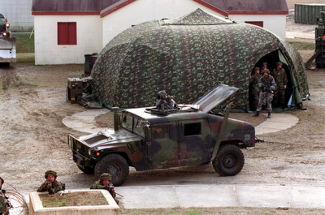 Marines from Charlie Company protect the Advanced Surgical Suite for Trauma Casualties medical tent at the Military Operations in Urban Terrain facility at Camp Lejeune, N.C., on Jan. 20, 1998, during Urban Warrior. Urban Warrior is the U.S. Marine Corps Warfighting Laboratory's series of limited objective experiments examining new urban tactics and experimental technologies. The experiment is being conducted by the Special Purpose Marine Air-Ground Task Force (Experimental) from Quantico, Va., and Charlie Company, 1st Battalion, 6th Marines from Camp Lejeune, with support from the 2nd Marine Expeditionary Force. 