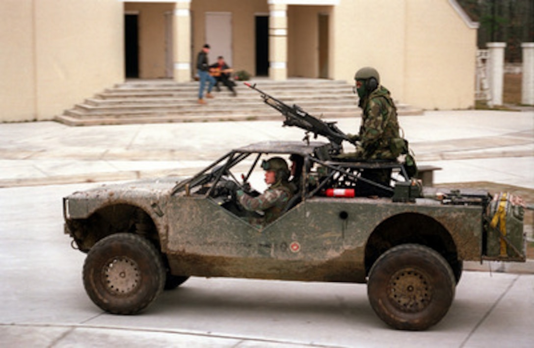 U.S. Marines from Charlie Company patrol the Military Operations in Urban Terrain facility in a Helo Transportable Tactical Vehicle (HTTV) at Camp Lejeune, N.C. on Jan. 20, 1998, during Urban Warrior. Urban Warrior is the U.S. Marine Corps Warfighting Laboratory's series of limited objective experiments examining new urban tactics and experimental technologies. The HTTV is one of the small, urban tactical vehicles the Marines are experimenting with. The experiment is being conducted by the Special Purpose Marine Air-Ground Task Force (Experimental) from Quantico, Va., and Charlie Company, 1st Battalion, 6th Marines from Camp Lejeune, with support from the 2nd Marine Expeditionary Force. 