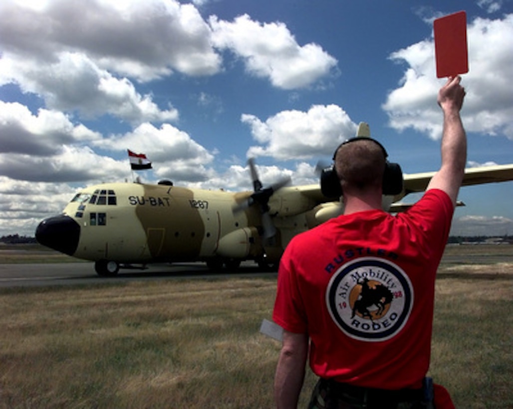 An Egyptian Air Force C-130 Hercules is marshaled into position upon arrival at McChord Air Force Base, Wash., for Air Mobility Rodeo 98 on June 16, 1998. Rodeo 98 tests the flight and ground skills of aircrews as well as the related skills of special tactics, security forces, aerial porters, aeromedical evacuation and maintenance members. The goal of the international airlift-tanker competition is to develop and improve techniques and procedures that enhance air mobility operations. 