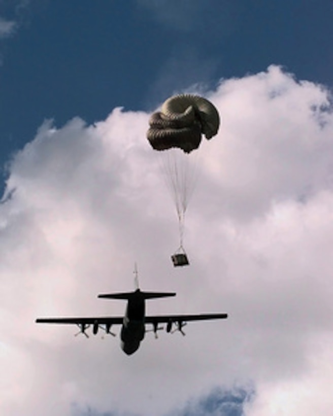 A C-130 Hercules drops a pallet during the heavy cargo portion of Air Mobility Rodeo 98 at McChord Air Force Base, Wash., June 23, 1998. Cargo pallets airdropped during Rodeo '98 test an aircrews ability to deliver cargo on-target to a designated drop zone. Rodeo 98 tests the flight and ground skills of aircrews as well as the related skills of special tactics, security forces, aerial porters, aeromedical evacuation and maintenance members. The goal of the international airlift-tanker competition is to develop and improve techniques and procedures that enhance air mobility operations. The Hercules is assigned to the 463rd Airlift Group, Little Rock Air Force Base, Ark. 