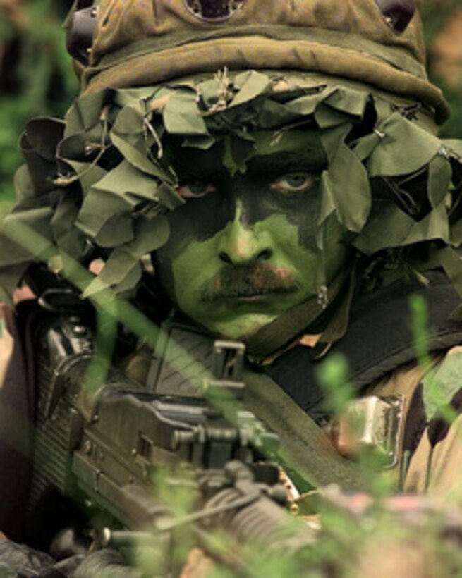 U.S. Air Force Master Sgt. Brian Frost waits for the opposing forces to attack his position during the combat tactics portion of Air Mobility Rodeo 98 at McChord Air Force Base, Wash., June 24, 1998. Rodeo 98 tests the flight and ground skills of aircrews as well as the related skills of special tactics, security forces, aerial porters, aeromedical evacuation and maintenance members. The goal of the international airlift-tanker competition is to develop and improve techniques and procedures that enhance air mobility operations. Frost is attached to the 315th Security Forces Squadron, Charleston Air Force Base, S.C. 