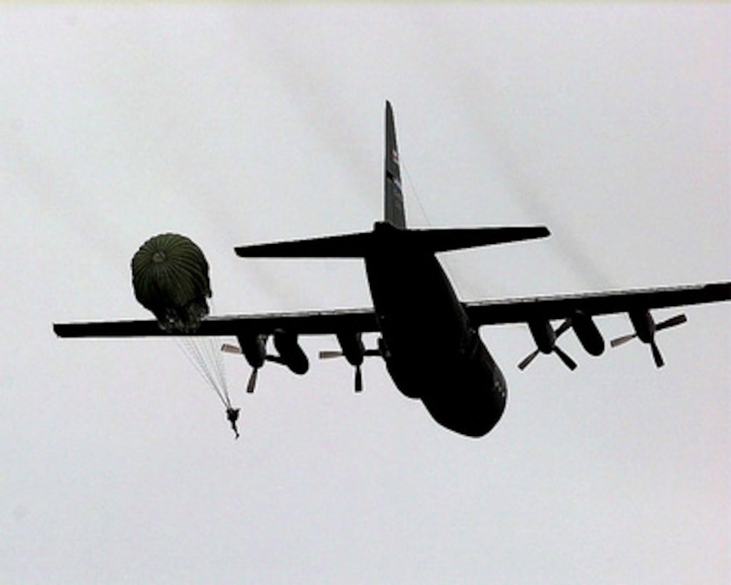 A paratrooper from the U.S. Army's 2nd Battalion, 1st Special Forces Group, Fort Lewis, Wash., jumps from a C-130 Hercules during Air Mobility Rodeo 98 at McChord Air Force Base, Wash., June 24, 1998. Rodeo 98 tests the flight and ground skills of aircrews as well as the related skills of special tactics, security forces, aerial porters, aeromedical evacuation and maintenance members. The goal of the international airlift-tanker competition is to develop and improve techniques and procedures that enhance air mobility operations. The Hercules is assigned to the Air Mobility Warfare Center, Little Rock Air Force Base, Ark. 