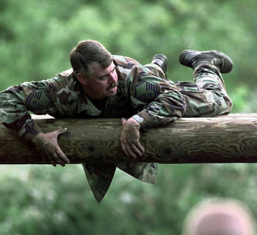 Master Sgt. James Roberts goes over the belly robber obstacle during the confidence course competition of Air Mobility Rodeo 98 at McChord Air Force Base, Wash., June 25, 1998. Rodeo 98 tests the flight and ground skills of aircrews as well as the related skills of special tactics, security forces, aerial porters, aeromedical evacuation and maintenance members. The goal of the international airlift-tanker competition is to develop and improve techniques and procedures that enhance air mobility operations. Roberts is attached to the 167th Airlift Wing, aerial port team, Martinsburg, W.Va. 