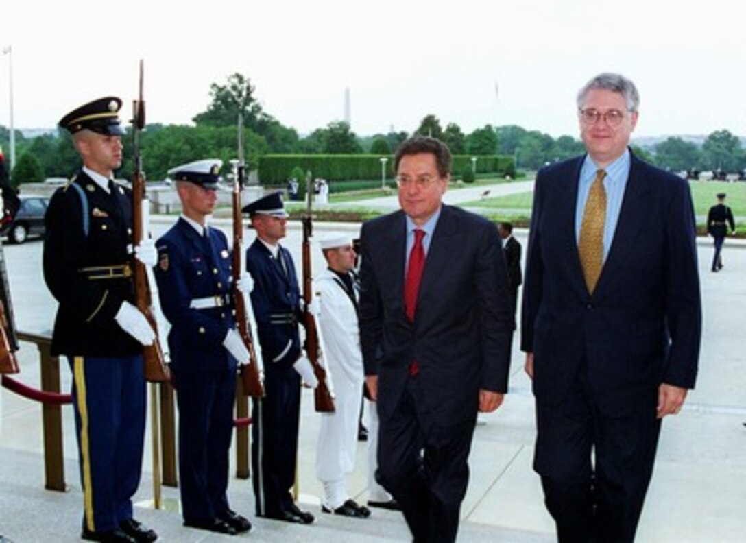 Deputy Secretary of Defense John J. Hamre (right) escorts Italian Deputy Minister of Defense Massimo Brutti (left) into the Pentagon on June 30, 1998. 