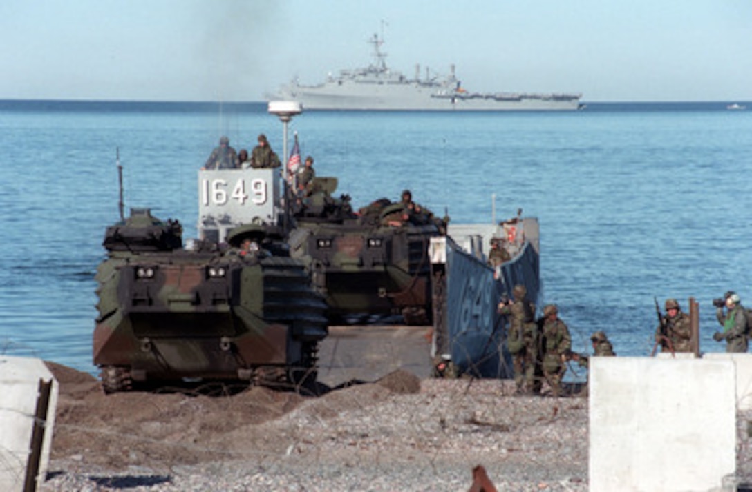 An amphibious assault vehicle (AAV) from the USS Nassau advances onto Green Beach during a mock invasion in Stephenville, Newfoundland. The maritime combined operational training exercise Unified Spirit '98 includes forces from Canada, Denmark, the United Kingdom, France, the United States , and other NATO nations. The exercise provides effective, realistic training to improve the skills they might employ during a NATO led peacekeeping support operation. 