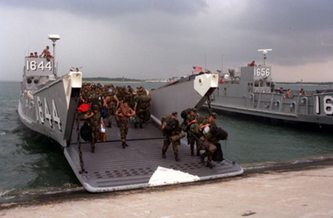 Marines and sailors come ashore in Morehead City, N.C., at the close of Unified Spirit '98, a maritime combined operational training exercise. The exercise includes forces from Canada, Denmark, the United Kingdom, France, the United States, and other NATO nations. It provides effective, realistic training to improve the skills needed during a NATO led peacekeeping support operation. 