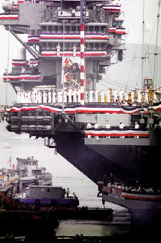 Sailors line the deck of the USS Independence CV 62 as it leaves its homeport of Yokosuka, Japan for the last time. The carrier is scheduled for decommissioning later this year and will be replaced by the USS Kitty Hawk CV 63. 