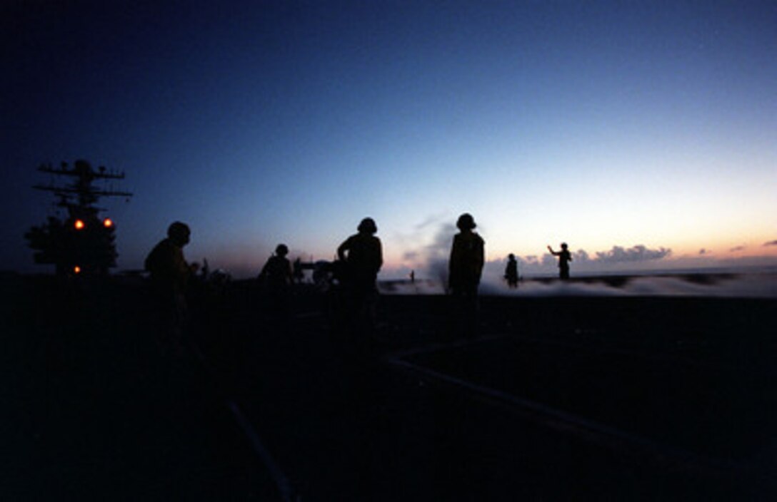 Day or night, flight operations don't stop. Sailors and officers on USS Carl Vinson CVN 70 work into the night to launch aircraft in support of RIMPAC '98. RIMPAC '98 is designed to enhance the tactical capabilities of participating units in major aspects of maritime operations at sea. RIMPAC '98 is the sixteenth in a series of Pacific naval exercises. 
