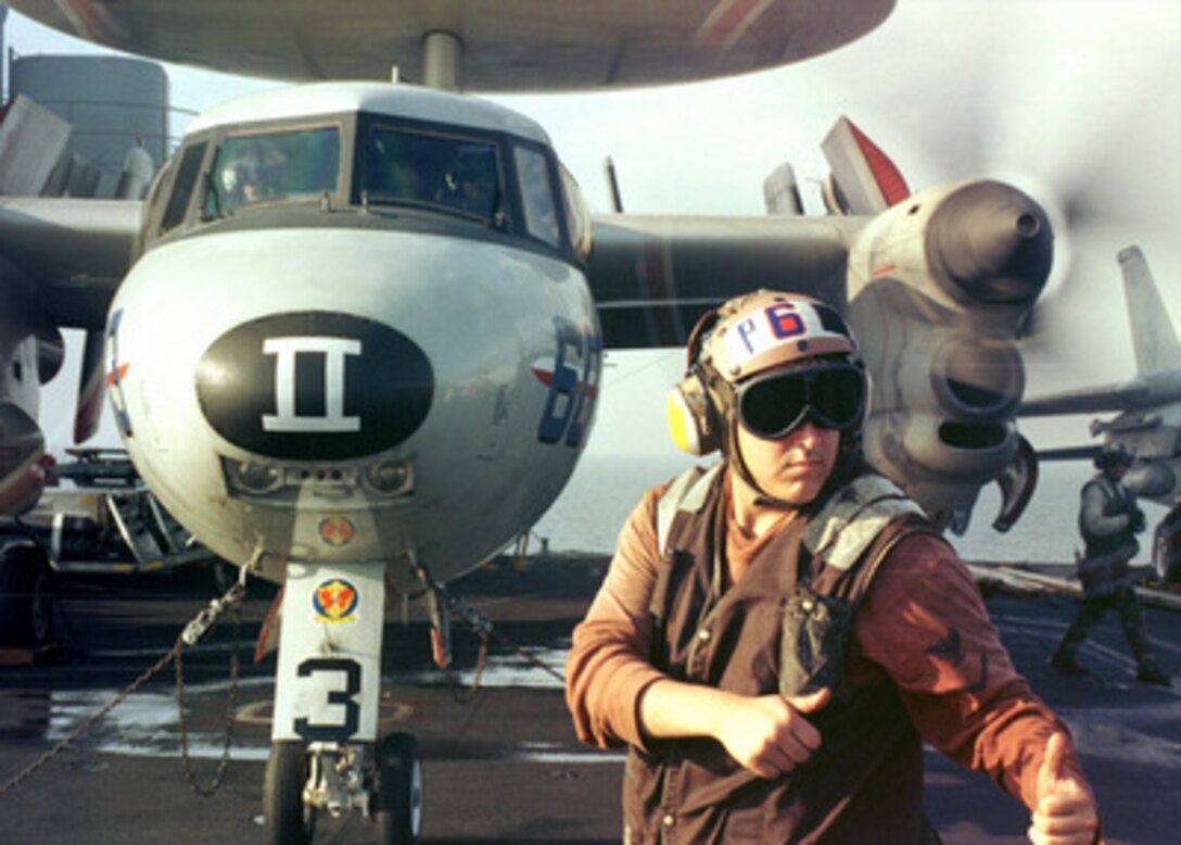 Aboard the aircraft carrier USS John C. Stennis CVN 74, an aircraft captain from Carrier Airborne Early Warning Squadron One Two One (VAW 121) directs an E-2C Hawkeye to "turn engines." Stennis is currently on a scheduled six month deployment to the Persian Gulf in support of Operation Southern Watch. 