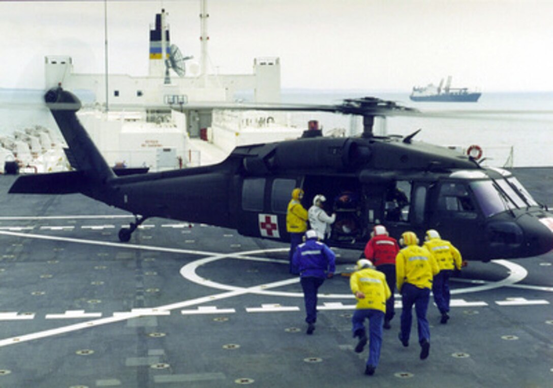 The flight deck crew of the USNS Comfort T AH 20, take part in assessing casualties as part of a practice exercise. The ship was off the coast of the island of Klaipeda near the country of Lithuania. Baltic Challenge '98 is the largest peace support exercise held in the Baltic region. Conducted in the spirit of the "Partnership-for-Peace (PFP)" program, the exercise will take place at sea, land and air training locations in and near Klaipeda on the western coast of Lithuania. 