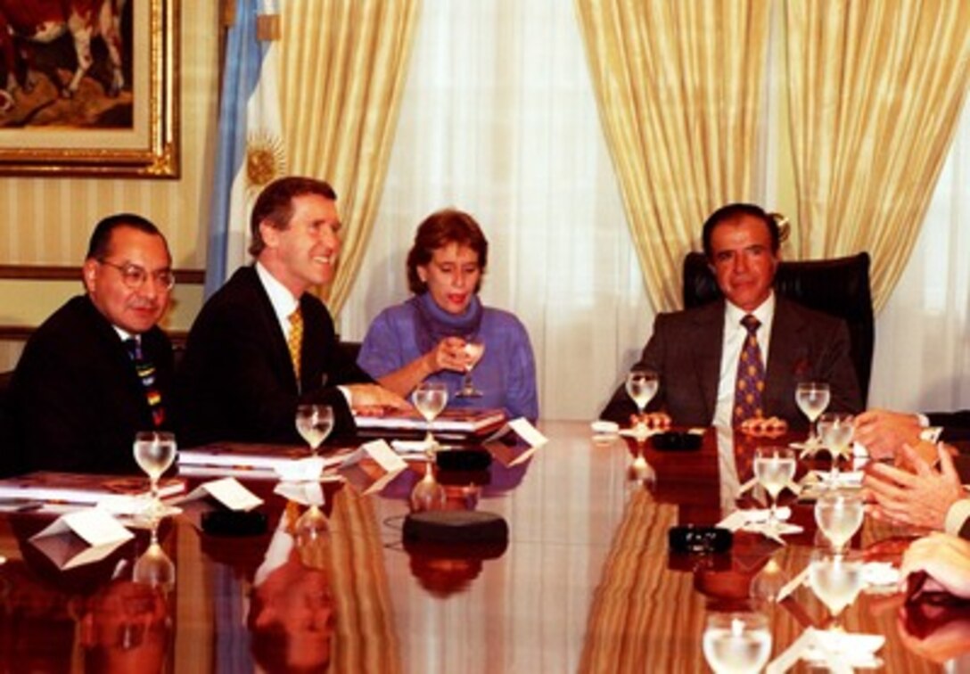 Secretary of Defense William S. Cohen (second from left) accompanied by Charge d' Affaires V. Manuel Rocha (left) pause for a photo as they meet with Argentinian President Carlos Saul Menem (right) in Buenos Aires, on May 23, 1998. Cohen and Menem are meeting to strengthen U.S.-Argentinian relationships since democracy has been established there. 