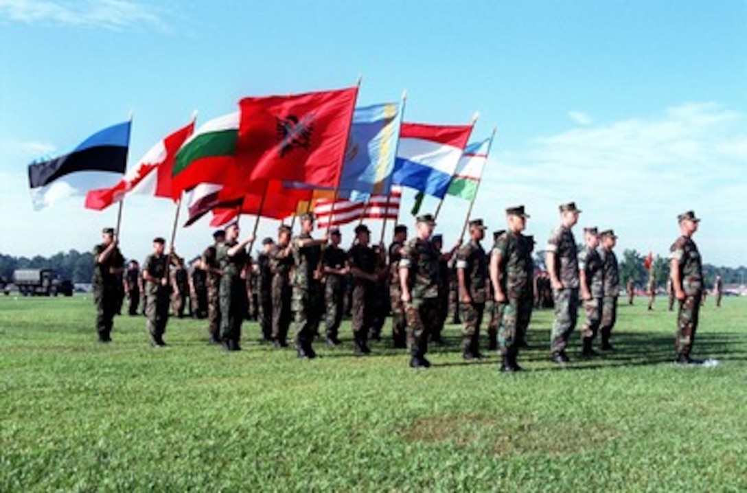 Flag bearers from several nations stand in formation on the parade field at Camp Lejeune, N.C., on June 3, 1998, for the opening ceremonies of Cooperative Osprey '98. Cooperative Osprey '98 is a Partnership for Peace situational training exercise designed to improve the interoperability of NATO and partner nations through the practice of combined peacekeeping and humanitarian relief operations. Partner nations include Albania, Bulgaria, Estonia, Georgia, Kazakstan, Kyrgyzstan, Latvia, Lithuania, Moldova, Poland, Romania, Ukraine, and Uzbekistan. Participating NATO nations include Canada, The Netherlands, and the United States. 