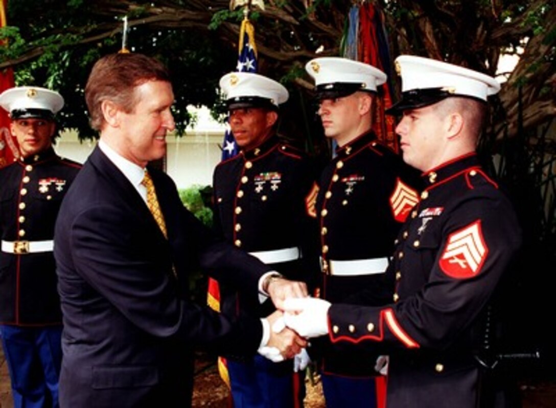 Secretary of Defense William S. Cohen presents mementos to U.S. Marines assigned to the U.S. Embassy, Brasilia, Brazil, on May 27, 1998. Cohen is in Brazil to meet with defense leaders to strengthen U.S.-Brazilian relationships. 