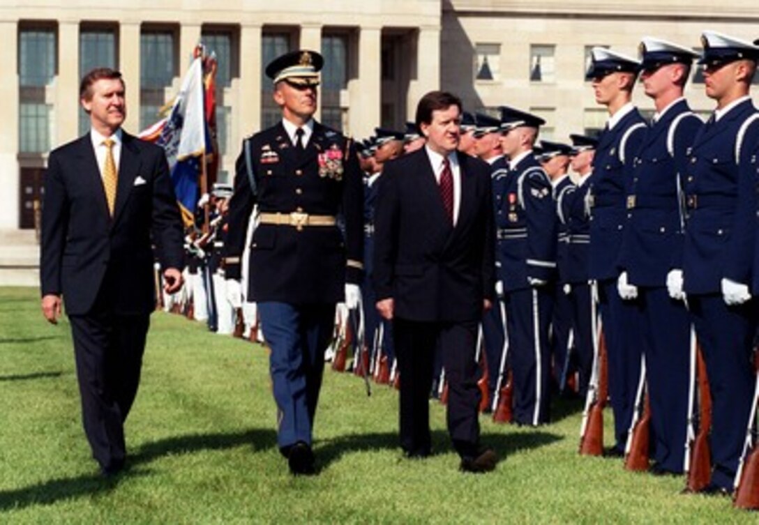 Secretary of Defense William S. Cohen (left) and United Kingdom Secretary of State for Defense George Robertson (right) inspect the joint services honor guard during welcoming ceremonies for Robertson at the Pentagon on June 3, 1998. Escorting Cohen and Robertson is the Commander of Troops for the Ceremony Col. Gregory Gardner (center), U.S. Army. Cohen and Robertson will meet to discuss defense issues of mutual concern to both nations. Gardner is the commander, 3rd U.S. Infantry (The Old Guard). 