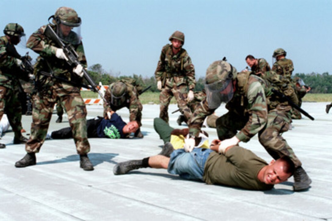 U.S. Marines demonstrate the proper procedure for subduing and handling rioters in a riot control class as part of Exercise Cooperative Osprey '98 at Marine Corps Base, Camp Lejeune, N.C., on June 4, 1998. Cooperative Osprey '98 is a Partnership for Peace situational training exercise designed to improve the interoperability of NATO and partner nations through the practice of combined peacekeeping and humanitarian relief operations. Partner nations include Albania, Bulgaria, Estonia, Georgia, Kazakstan, Kyrgyzstan, Latvia, Lithuania, Moldova, Poland, Romania, Ukraine, and Uzbekistan. Participating NATO nations include Canada, The Netherlands, and the United States. The rioters in this situation are role playing U.S. Marines. 
