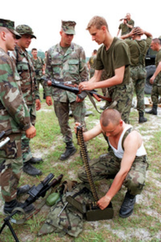 Two Polish soldiers show a group of Marines their Polish made AK-47 7.62 mm rifle with a 14 mm grenade launcher, at Landing Zone Coot, Camp Lejeune, N.C., on June 5, 1998, during Exercise Cooperative Osprey '98. Cooperative Osprey '98 is a Partnership for Peace situational training exercise designed to improve the interoperability of NATO and partner nations through the practice of combined peacekeeping and humanitarian relief operations. Partner nations include Albania, Bulgaria, Estonia, Georgia, Kazakstan, Kyrgyzstan, Latvia, Lithuania, Moldova, Poland, Romania, Ukraine, and Uzbekistan. Participating NATO nations include Canada, The Netherlands, and the United States. 