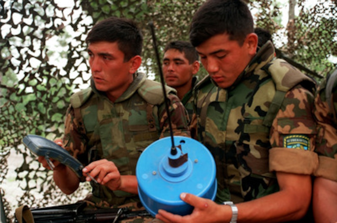 Uzbekistanian soldiers get a closer look at the types of mines and explosives they may encounter in the future as part of situational training during Exercise Cooperative Osprey '98 on June 5, 1998, at Marine Corps Base, Camp Lejeune, N.C. The soldiers are being taught the proper methods of identifying, marking, and reporting mines, unexplored ordnance, and improvised explosive devices. Cooperative Osprey '98 is a Partnership for Peace situational training exercise designed to improve the interoperability of NATO and partner nations through the practice of combined peacekeeping and humanitarian relief operations. Partner nations include Albania, Bulgaria, Estonia, Georgia, Kazakstan, Kyrgyzstan, Latvia, Lithuania, Moldova, Poland, Romania, Ukraine, and Uzbekistan. Participating NATO nations include Canada, The Netherlands, and the United States. 