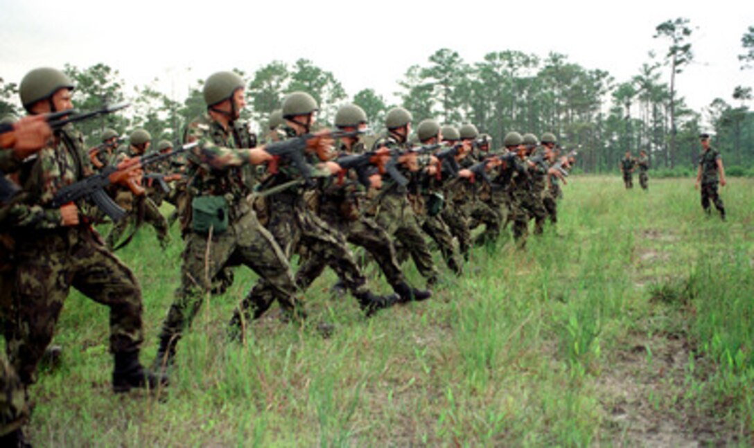 Romanian soldiers form a line across the field as they practice riot control procedures during Exercise Cooperative Osprey '98 on June 6, 1998, at Marine Corps Base, Camp Lejeune, N.C. Cooperative Osprey '98 is a Partnership for Peace situational training exercise designed to improve the interoperability of NATO and partner nations through the practice of combined peacekeeping and humanitarian relief operations. Partner nations include Albania, Bulgaria, Estonia, Georgia, Kazakstan, Kyrgyzstan, Latvia, Lithuania, Moldova, Poland, Romania, Ukraine, and Uzbekistan. Participating NATO nations include Canada, The Netherlands, and the United States. 