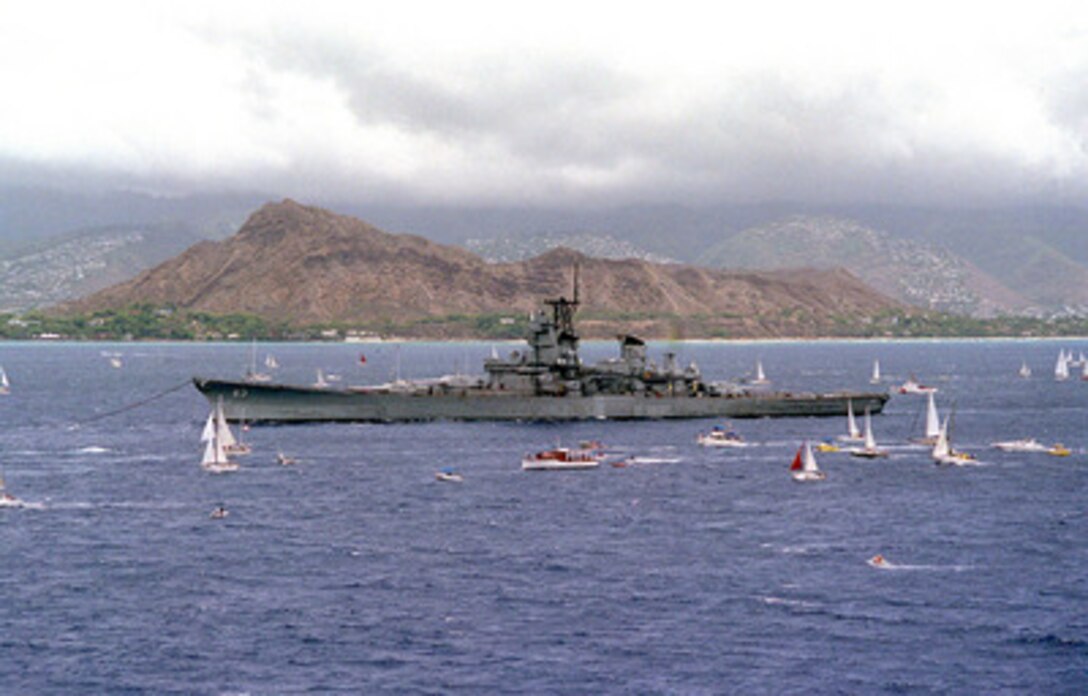 The battleship USS Missouri (BB 63) is towed past Diamond Head en route to Pearl Harbor, Hawaii, on June 21, 1998. Secretary of the Navy John H. Dalton signed the Donation Agreement on May 4th, allowing Missouri to be used as a museum near the Arizona Memorial. The ship was towed from Bremerton, Wash. 