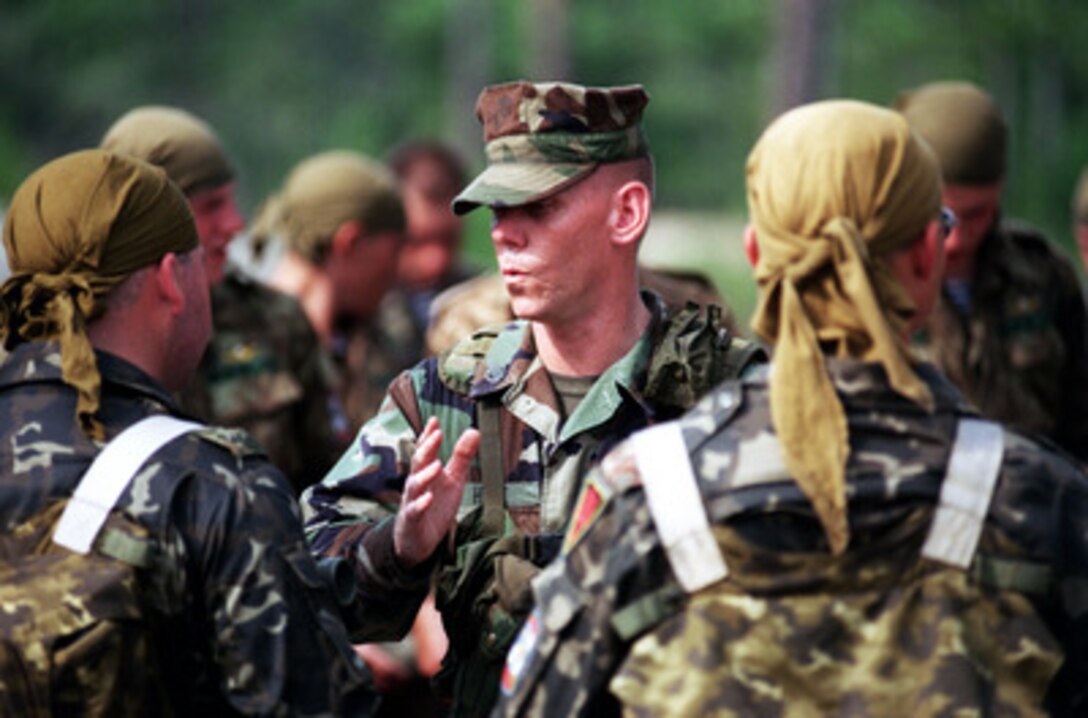 U.S. Marine Staff Sgt. Hale briefs two Ukrainian soldiers on mine probing procedures as part of situational training during Exercise Cooperative Osprey '98 on June 6, 1998, at Marine Corps Base, Camp Lejeune, N.C. The soldiers are being taught the proper methods of identifying, marking, and reporting mines, unexplored ordnance, and improvised explosive devices. Cooperative Osprey '98 is a Partnership for Peace situational training exercise designed to improve the interoperability of NATO and partner nations through the practice of combined peacekeeping and humanitarian relief operations. Partner nations include Albania, Bulgaria, Estonia, Georgia, Kazakstan, Kyrgyzstan, Latvia, Lithuania, Moldova, Poland, Romania, Ukraine, and Uzbekistan. Participating NATO nations include Canada, The Netherlands, and the United States. Hale is attached to the 3rd Battalion, 8th Marine Regiment. 