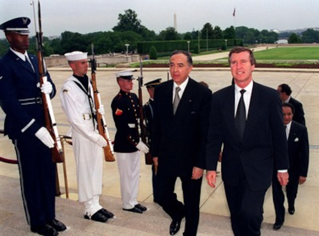 Secretary of Defense William S. Cohen (right) escorts visiting Minister of National Defense Habib Ben Yahia of the Republic of Tunisia into the Pentagon, June 19, 1998. The two defense leaders met to discuss a range of security issues of interest to both nations. 