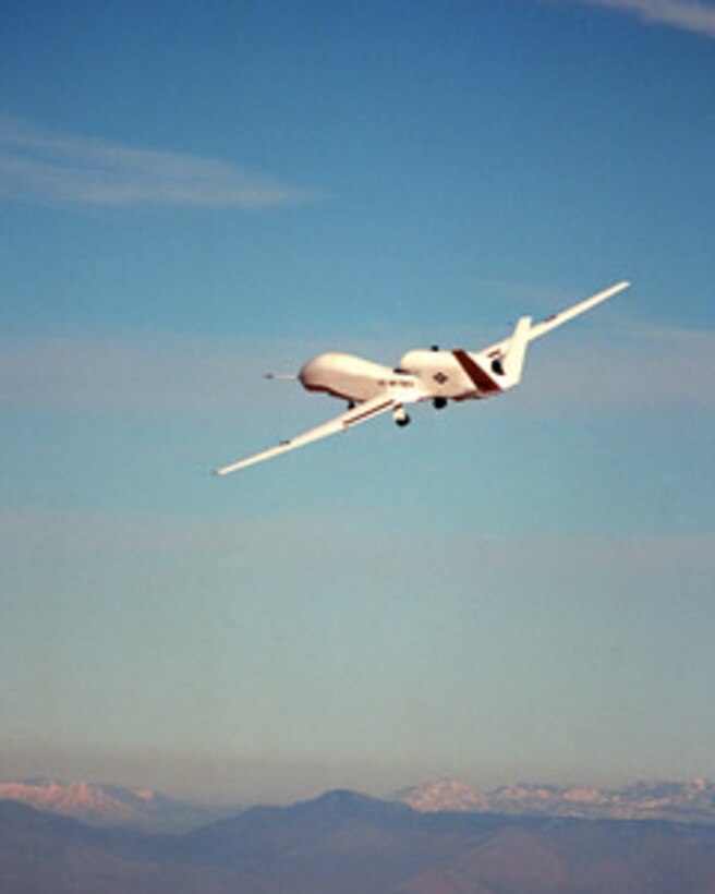 Global Hawk, the Department of Defense's newest reconnaissance aircraft, flies over Edwards Air Force Base, Calif., on Feb. 28, 1998, during its first flight. Global Hawk is a high-altitude, long-endurance, unmanned air vehicle designed to operate with a range of 13,500 nautical miles, at altitudes up to 65,000 feet and with an endurance of 40 hours. During a typical reconnaissance mission, the aircraft can fly 3,000 miles to an area of interest, remain on station for 24 hours, survey an area the size of the state of Illinois (40,000 square nautical miles), and then return 3,000 miles to its operating base. Sensors onboard the aircraft can provide near-real-time imagery of the area of interest to the battlefield commander via world-wide satellite communication links and the system's ground segment. 